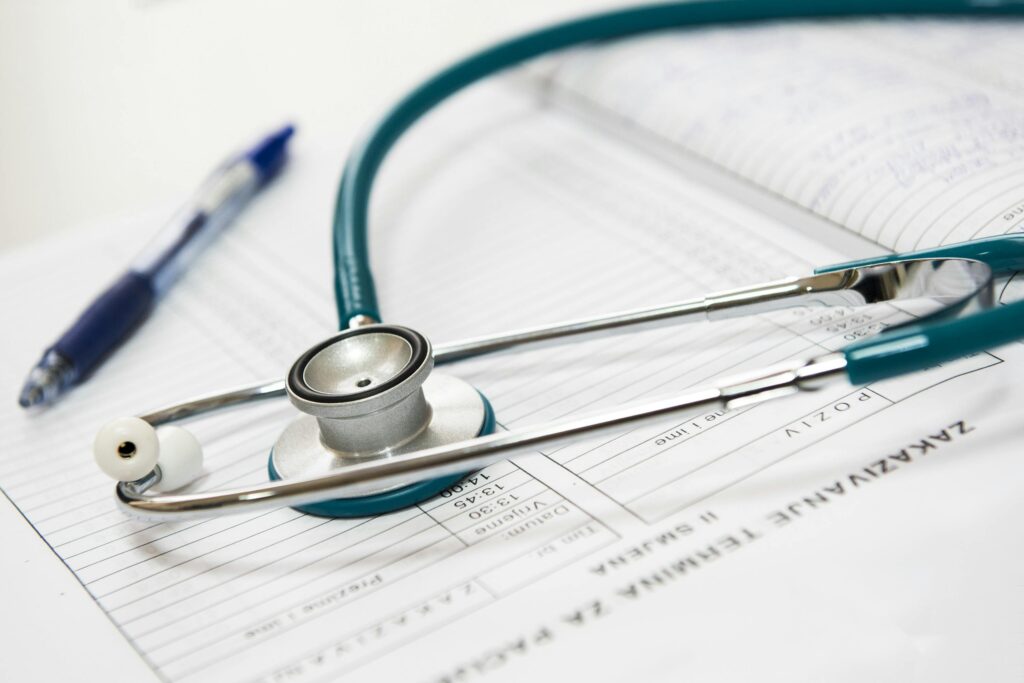 Healthy lifestyle concept with a doctor writing notes and medical equipment on a table.